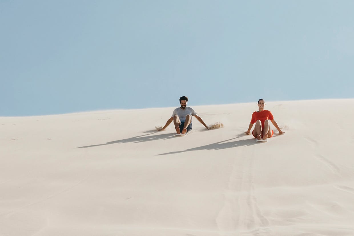 Two people sanduning.